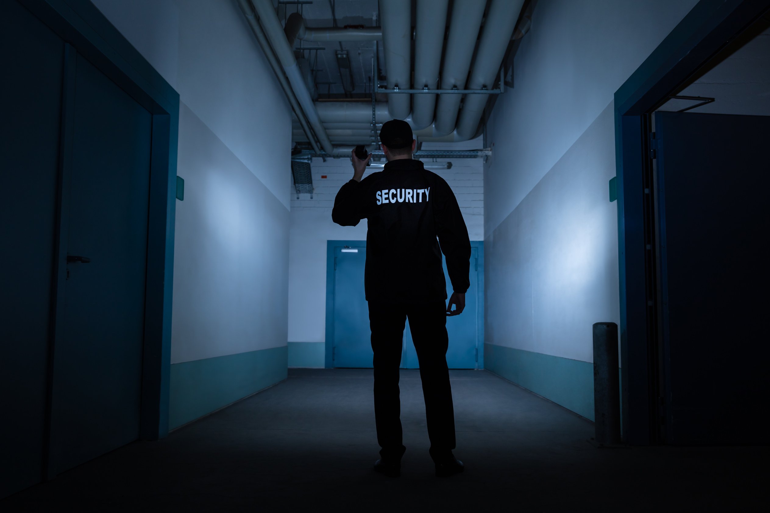 Male Security Guard Standing In Corridor